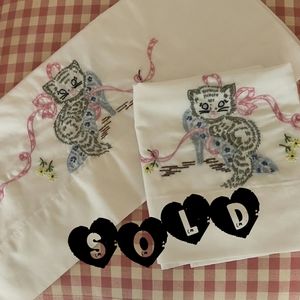 Set of hand embroidered, standard-sized, pillow cases.